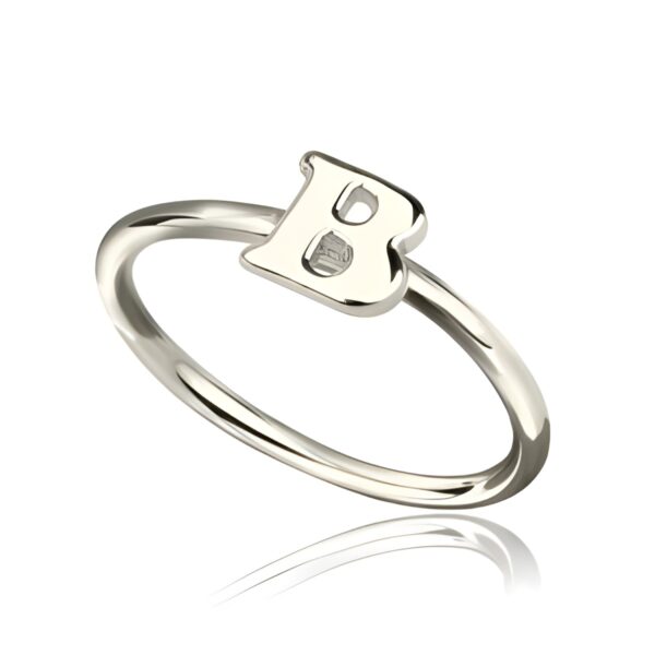 Hand-engraved sterling silver initial ring close-up