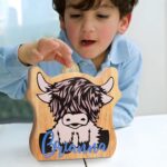 Watch Their Dreams Grow – Custom Highland Cow Wooden Coin Bank – A Cherished Keepsake for Children and Family Moments - Image 4